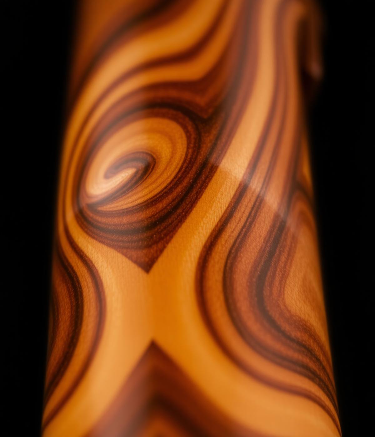 Macro view of figured wood grain on a turned pen barrel